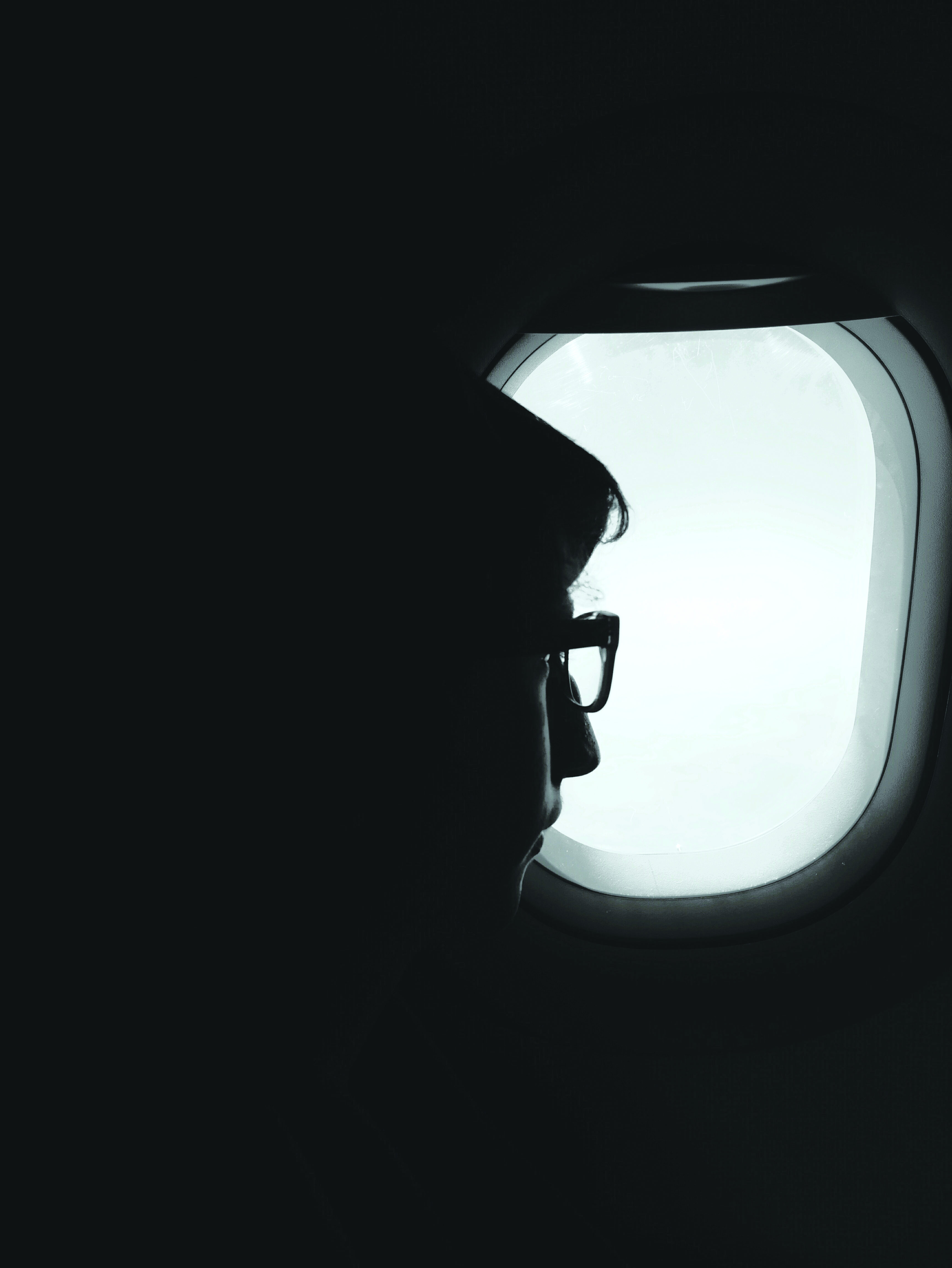 Someone looking outside an airplane window